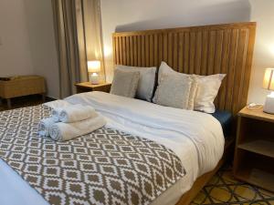 a bedroom with a bed with a teddy bear on it at La Perle d'Argan in Essaouira