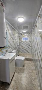 a bathroom with a toilet and a sink at Arista Yurt Camp in Karakol +60 photos