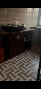 a kitchen with a stove and a floor at Rehoboth compound in Lekki