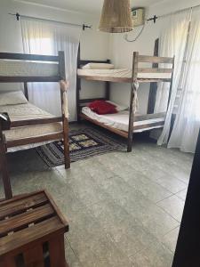 a room with two bunk beds and a table at Posada Bella Vista 1 y 2 in El Volcán +11 photos