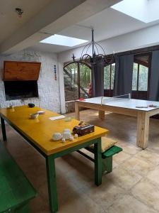 a living room with a ping pong table and a ping pong table at Posada Bella Vista 1 y 2 in El Volcán