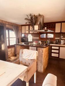 a kitchen with a couch and a table in a room at Posada Bella Vista 1 y 2 in El Volcán