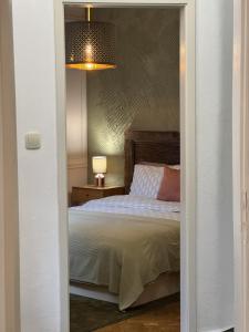 a bedroom with a bed and a lamp and a light at Vanito Art Escape in Nesebar