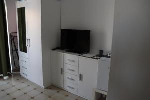 a white cabinet with a television on top of it at Villa Purić in Rovinj