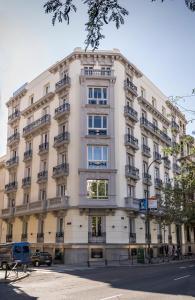a large white building on a city street at Safestay Madrid Central in Madrid