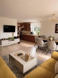 a living room with a couch and a table at Agroturystyka Parlińskie Wody II in Parlino
