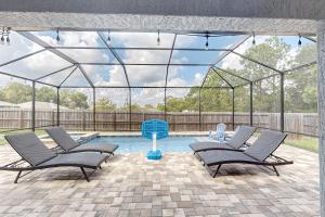 a patio with two chairs and a swimming pool at Poolside Oasis! Family-Friendly Summerfield Escape in Orange Blossom Hills