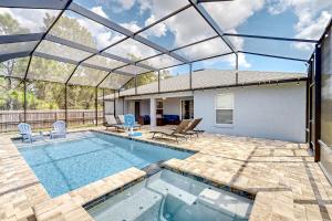a swimming pool with a glass roof over a house at Poolside Oasis! Family-Friendly Summerfield Escape in Orange Blossom Hills