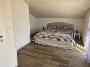 a bedroom with a bed and a wooden floor at Bell Air-Plus in Les Hauts-Geneveys