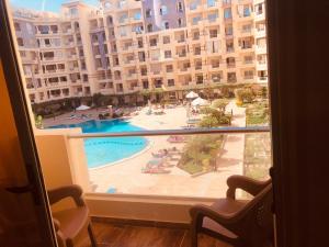 a view of a swimming pool from a hotel window at فلورنزا خمسين in Hurghada
