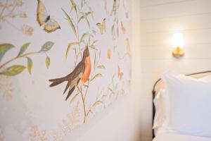 a bedroom with a bird painting on the wall at Kildahl House - Boutique Farmhouse Suite #4 in West Dundee