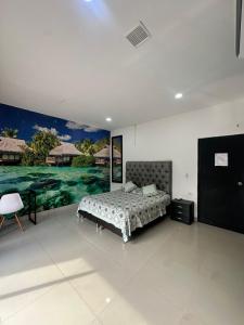 a bedroom with a bed and a painting on the wall at APARTAMENTO CONFORTABLe 200 in Arauca +33 photos