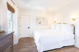 a white bedroom with a white bed and a window at Kildahl House - Boutique Farmhouse Suite #4 in West Dundee +16 photos