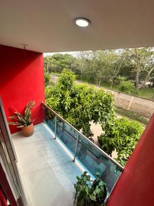 a balcony with a view of a garden at APARTAMENTO CONFORTABLe 200 in Arauca