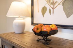 a bowl of fruit on a table next to a lamp at Kildahl House - Boutique Farmhouse Suite #4 in West Dundee