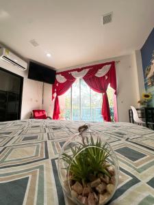 a room with a bed with a plant in a bowl on it at APARTAMENTO CONFORTABLe 200 in Arauca