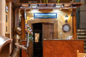 a entrance to a store with a clock on the wall at Hotel Los Escudos in Pátzcuaro