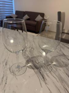 two wine glasses sitting on top of a marble table at Quiet Private Room in El Pueblito