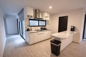 a kitchen with white cabinets and a counter top at Quiet Private Room in El Pueblito