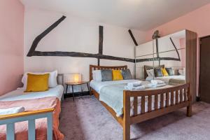 a bedroom with two beds and a window at 2BR House with WiFi - Sleeps 5 - Gloucester in Gloucestershire