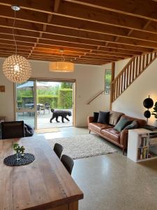 a living room with a table and a couch at Beech Hill - Pet Friendly Holiday Home in Tasman