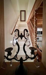a chandelier in a house with a staircase at Beech Hill - Pet Friendly Holiday Home in Tasman