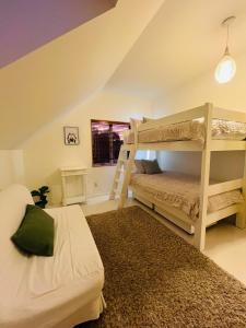 a bedroom with two bunk beds in a attic at Beech Hill - Pet Friendly Holiday Home in Tasman +28 photos