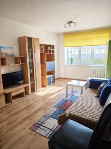 a living room with a couch and a table at Apartamenti dzīvoklis Ogre. in Ogre
