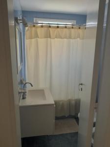 a bathroom with a sink and a shower curtain at Departamento in Mar del Plata