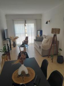 a living room with a table and a couch at Departamento in Mar del Plata