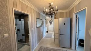 a hallway with a refrigerator and a chandelier at Bellevue in Colmar
