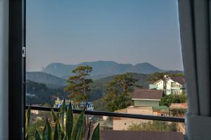 a view from a window of a city with mountains at Zenora Hillside Garden in Da Lat +45 photos