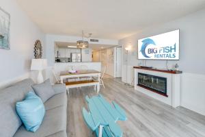 a living room with a couch and a table at NEW Baywatch Remodled with Direct Oceanfront Views in Myrtle Beach