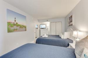 a bedroom with two beds and a tv in it at NEW Baywatch Remodled with Direct Oceanfront Views in Myrtle Beach