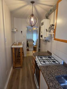 a kitchen with a stove and a counter top at Olivos Calm Stay in Olivos