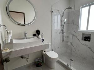 a bathroom with a toilet and a sink and a mirror at El Encanto Inn & Suites in San José del Cabo +34 photos