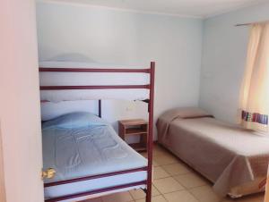a bedroom with two bunk beds and a bed at Cabañas rústico in San Pedro de Atacama