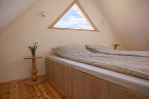 a bed in a room with a window at Watan A&D in Buna
