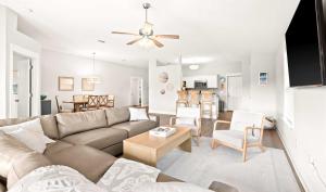 a living room with a couch and a table at New Home with Fenced Yard Large Deck & Fire Pit in Navarre
