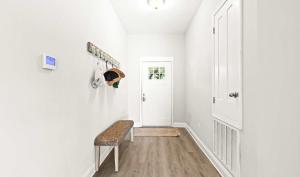 a hallway with a bench and a door at New Home with Fenced Yard Large Deck & Fire Pit in Navarre +26 photos