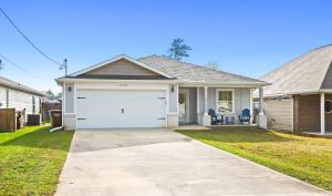 a house with a white garage at New Home with Fenced Yard Large Deck & Fire Pit in Navarre