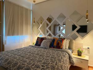 a bedroom with a large bed with colorful pillows at Mirador Capo Negro in Cabo Negro