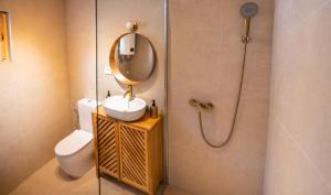 a bathroom with a toilet and a sink and a mirror at Watan A&D in Buna +41 photos