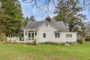 a white house with a porch on a yard at Historic 1800s Cornwall-On-Hudson Cottage! in Cornwall-on-Hudson