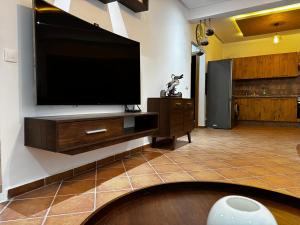 a living room with a large flat screen tv on a wall at Mirador Capo Negro in Cabo Negro