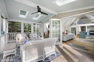 a living room with chairs and a ceiling fan at The Songbird by Juniper Holiday + Home in New Buffalo