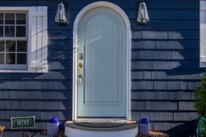 a blue front door of a house with a blue door at The Songbird by Juniper Holiday + Home in New Buffalo +40 photos