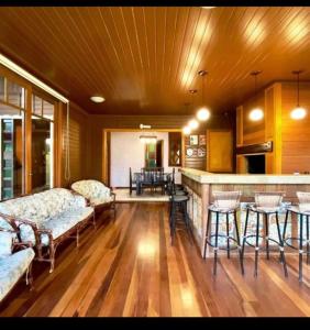 a living room with two couches and a bar at Pousada Laranjal em Pelotas in Pelotas