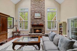 a living room with a couch and a fireplace at Pete's Place by Juniper Holiday + Home in Sawyer