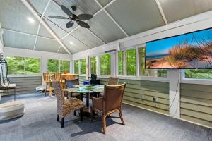 a dining room with a tv and a table and chairs at Pete's Place by Juniper Holiday + Home in Sawyer +42 photos